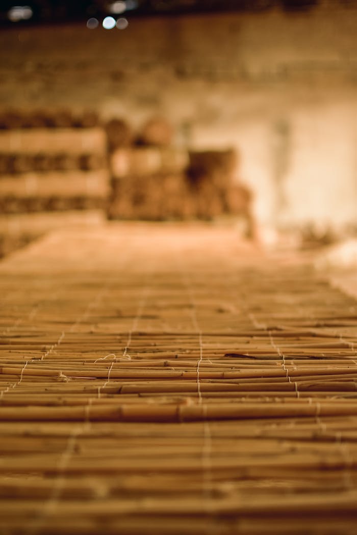 Focused shot of bamboo sticks arranged closely in warm indoor lighting.